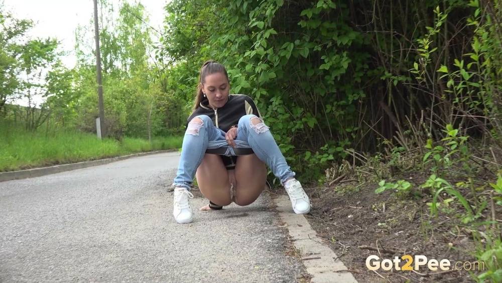 Clothed girl pulls down ripped jeans for a pee while bicyclists pass by her - #9