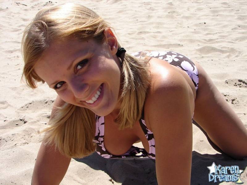 Blonde teen Karen models a bikini while on a patch of sand - #5
