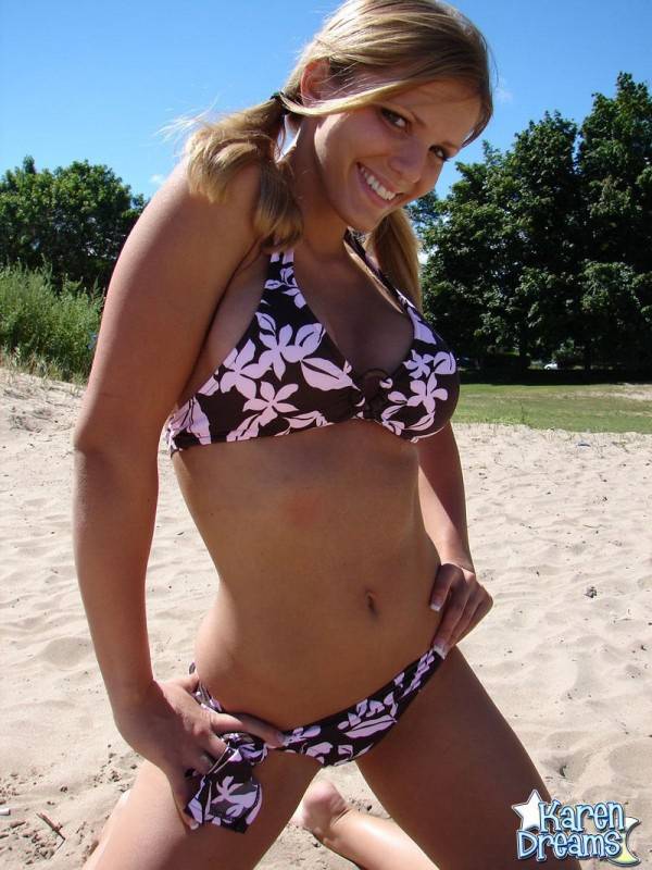 Blonde teen Karen models a bikini while on a patch of sand - #7