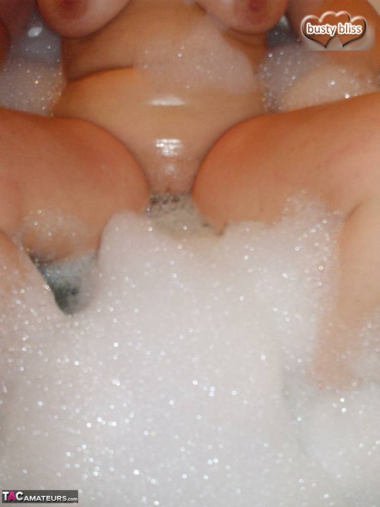 Older amateur Busty Bliss licks her lips during a playful bubble bath - #7