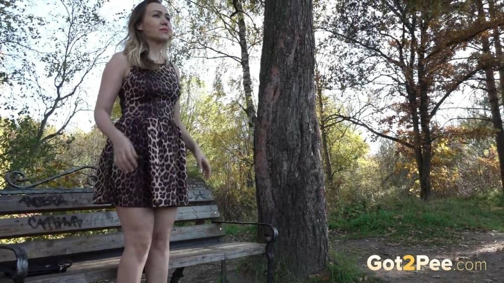 Caucasian chick Diana takes a piss while sitting on a bench in a park - #1