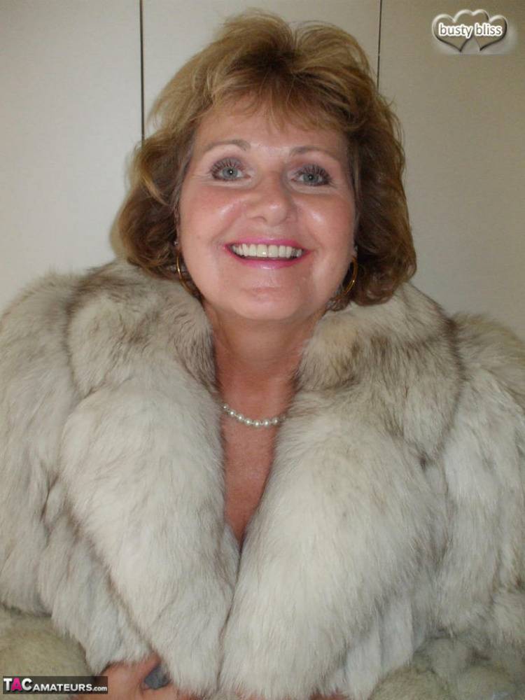 Older woman Busty Bliss licks her lips before showing her boobs in a fur coat - #11