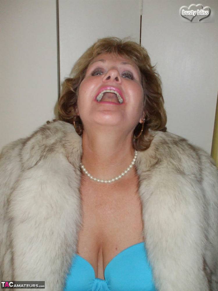 Older woman Busty Bliss licks her lips before showing her boobs in a fur coat - #15