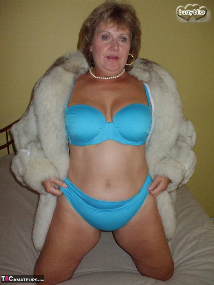 Older woman Busty Bliss licks her lips before showing her boobs in a fur coat - #9