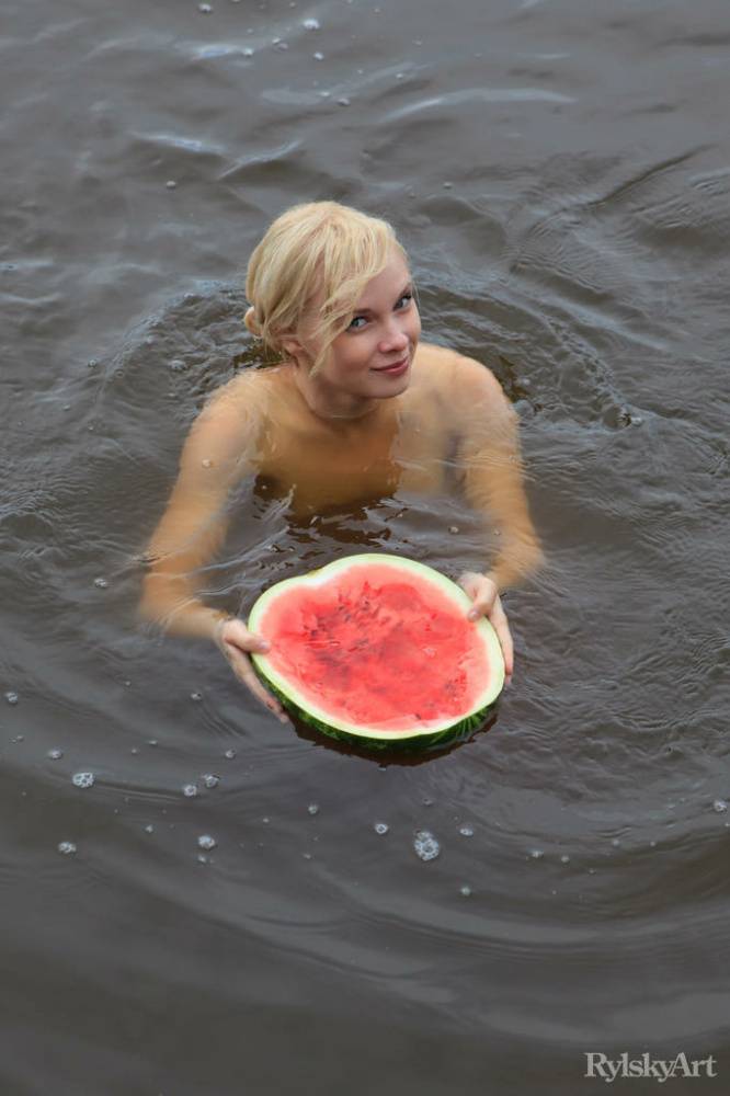 Beautiful blonde Feeona eats a watermelon while posing naked on lakeside dock - #10