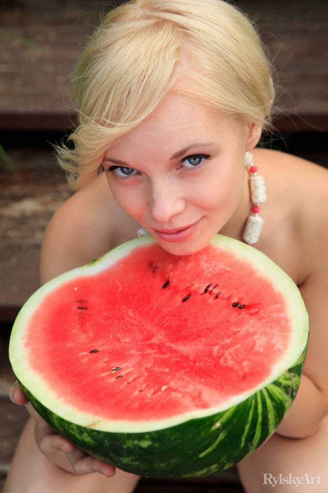 Beautiful blonde Feeona eats a watermelon while posing naked on lakeside dock - #4