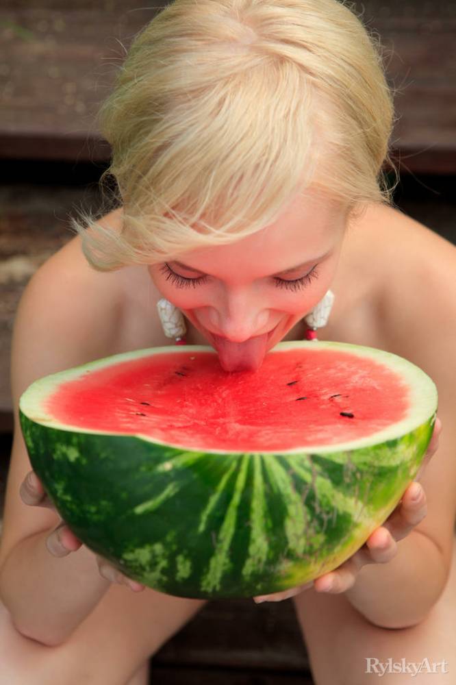 Beautiful blonde Feeona eats a watermelon while posing naked on lakeside dock - #8