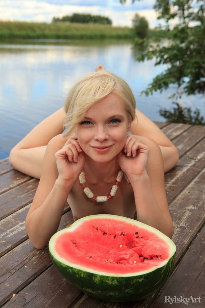 Beautiful blonde Feeona eats a watermelon while posing naked on lakeside dock - #11
