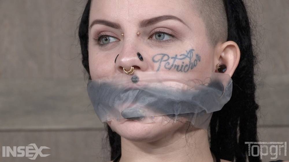 Pierced and tatted girl is worked over by a woman while restrained in bondage - #12
