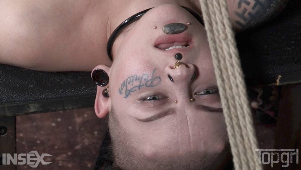 Pierced and tatted girl is worked over by a woman while restrained in bondage - #10