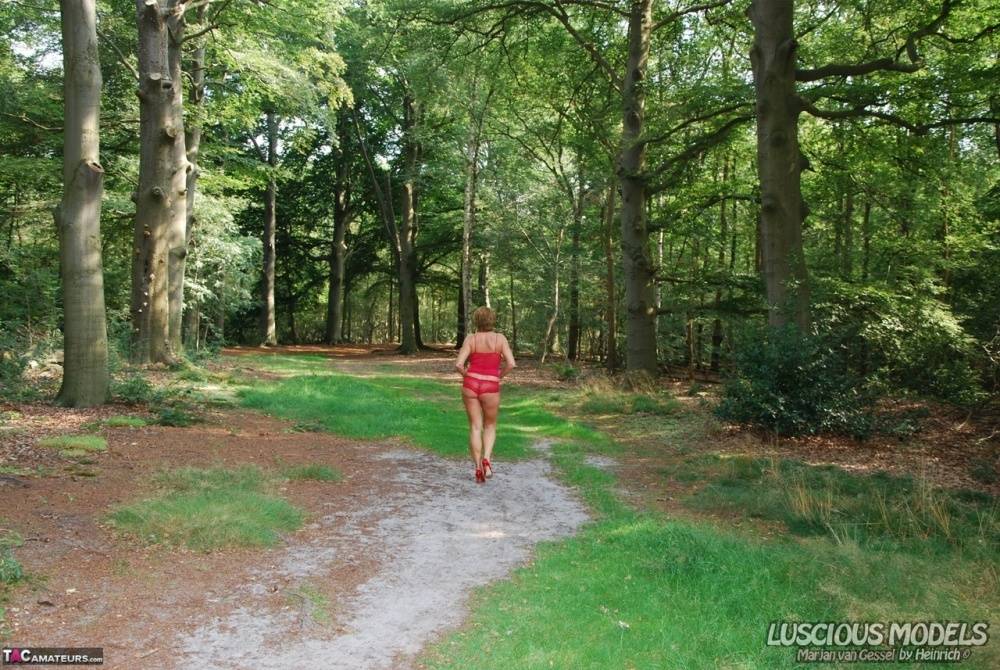 Tall older woman puts her great tits on display while in a wooded setting - #15