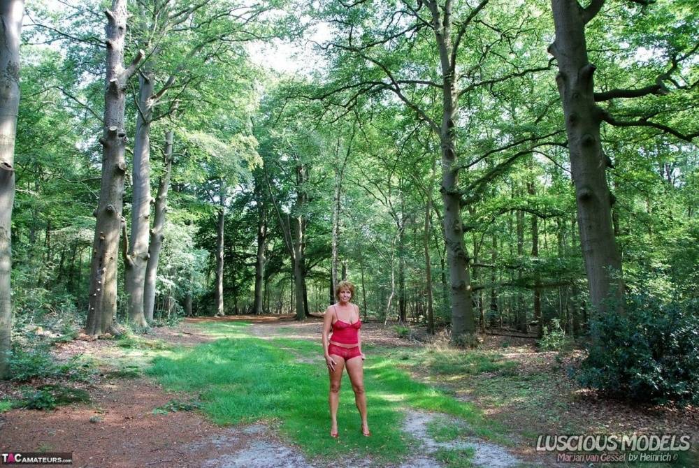 Tall older woman puts her great tits on display while in a wooded setting - #14