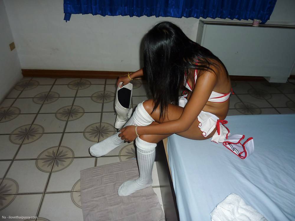 Thai female Tata posing naked on bed after peeling off socks and micro skirt - #7