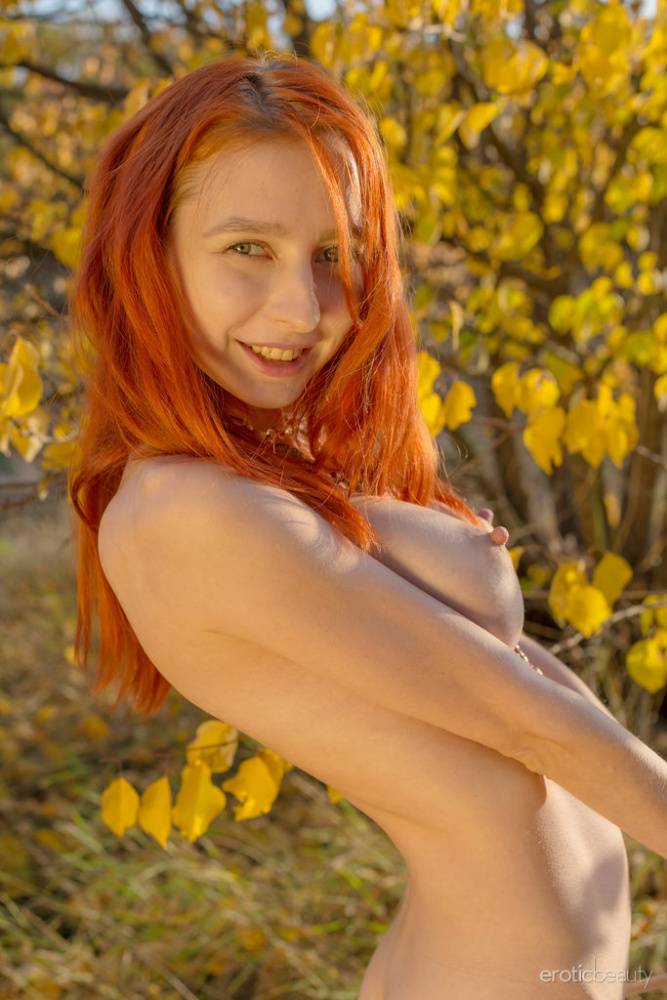 Pale redhead with big tits Olivia I poses her naked teen body in sparse woods - #13