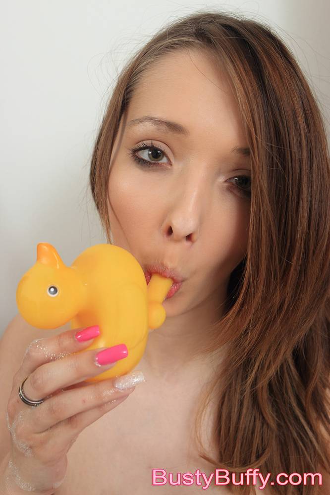 Amateur model Buffy holds a rubber duck while showing her giant breasts - #4