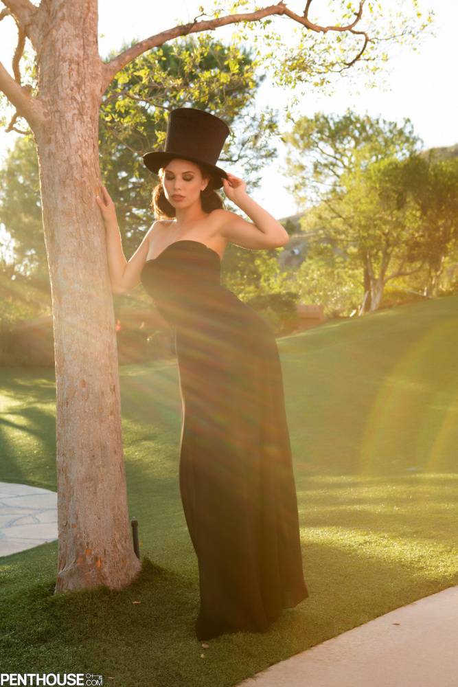 Sexy female Aidra Fox doffs a black dress and top hat to pose nude in a yard - #15