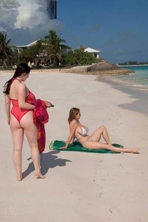 Busty lesbian girls let their huge knockers loose to kiss & lick on the beach - #main