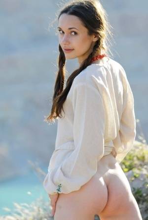 Teen model Ilona B poses nude in pigtails high above ocean waters - #main