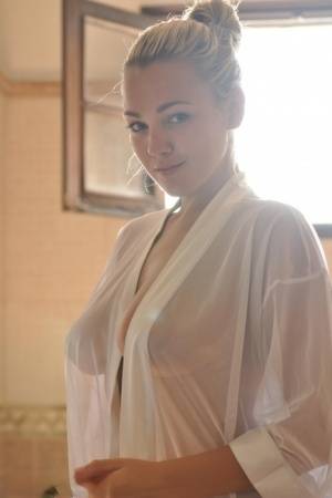 Beautiful blonde chick Jodie Gasson pulls on a see thru blouse in the morning - #main