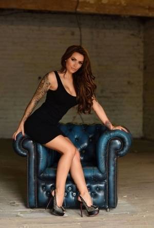 British glamour model Gemma Massey peels off black dress on leather chair - #main