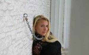 Fully clothed blonde is fastened to a wall with chains in handcuffs - #main
