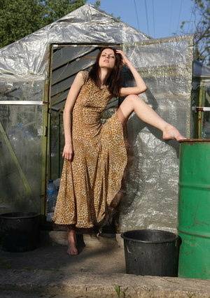 18 year old brunette Emma gets bare naked while gardening by a greenhouse - #main