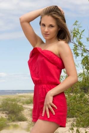 Young blonde girl Selena shows her lithe body on a deserted stretch of beach - #main