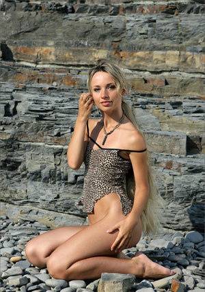 Dirty blonde beauty cradles her tan lined tits while naked against a rock face - #main