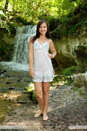 Solo girl Rosalin E removes lingerie to model naked in front of a waterfall - #main