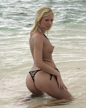 Sexy blonde models a skimpy thong during an ocean solo shoot - #main