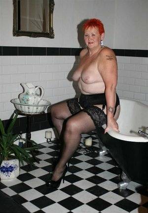Older redhead Valgasmic Exposed models on the side of a claw tub in hosiery - #main