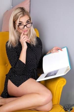 Geeky blonde Amelia undresses on a chair before playing with her shaved pussy - #main