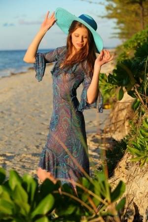 Teen beauty Nicole K modeling naked on beach wearing a sun hat - #main