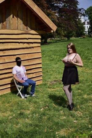 Natural redhead masturbates on a lawn before teasing a masked man - #main