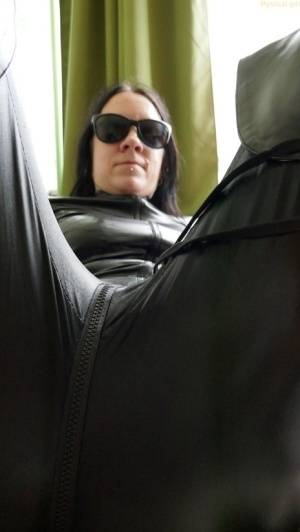 Dark haired amateur models a leather catsuit while wearing dark sunglasses - #main