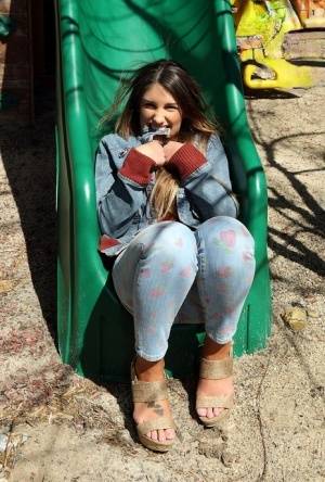 Busty amateur female August Ames spreading pussy lips apart on swing set - #main