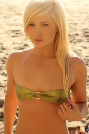 Young looking blonde girl Ashlie Madison cups her flat chest via bikini top - #main