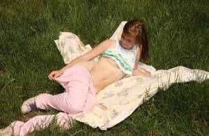 Teen amateur disrobes before fingering her pussy on a blanket out in the yard on clubgf.com