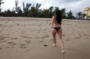 Naughty brunette amateur in bikini demonstrating her goods outdoor on clubgf.com