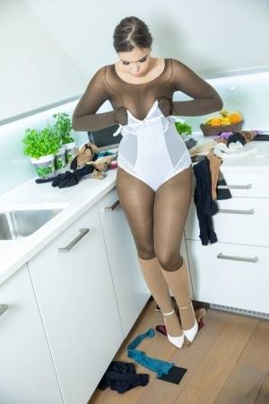 Busty girl Sofia Lee adorns herself in multiple layers of pantyhose on clubgf.com