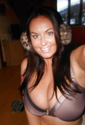 Buxom brunette babe Sarah Nicole Randall posing topless with ear muffs on clubgf.com