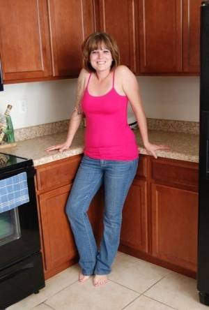 Redhead amateur Misty B gets completely naked in her kitchen on clubgf.com