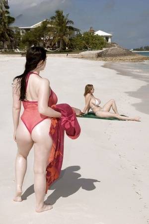 Fervent lesbians stripping nude and playing with dildos on the beach on clubgf.com