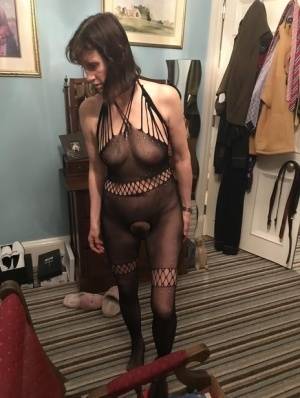 Older amateur Slut Scot Susan shows her beaver on a bed in a bodystocking on clubgf.com