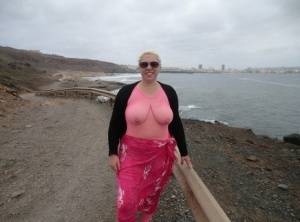 Aged lady Barby looses her big tits from a crotchless bodystocking by the sea on clubgf.com