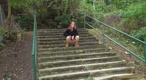 Natural redhead Chrissy Fox squats for a pee on a set of public steps on clubgf.com
