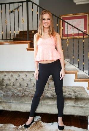 Slim white girl Jillian Janson wears a nice smile while removing spandex pants on clubgf.com