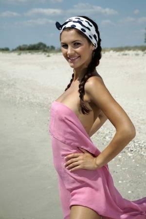 Teen solo girl Lola B strikes glamorous nude poses while at the beach on clubgf.com