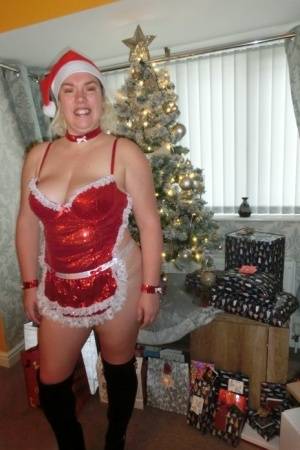 Busty blonde Barby masturbates her shaved pussy near the Christmas tree on clubgf.com