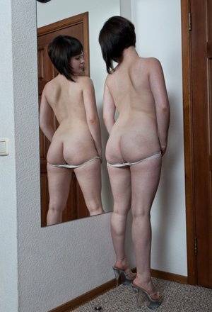 White teen with a full bush admires herself in mirror while disrobing on clubgf.com